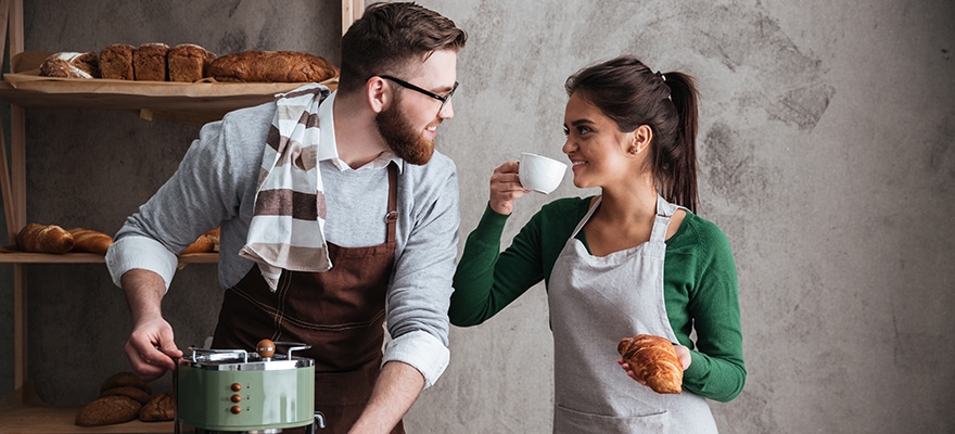 cheerful-loving-couple-bakers-drinking-coffee-PCAVA6B-2-880x400